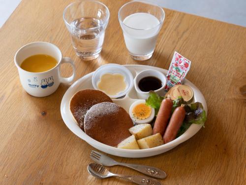 a plate of food with eggs and bread on a table at KUMU Kanazawa by THE SHARE HOTELS in Kanazawa