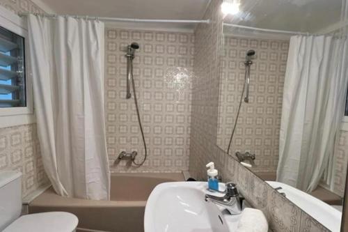 a bathroom with a shower and a sink and a tub at Apartamento en Palamos delante del mar in Palamós