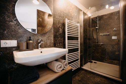 a bathroom with a sink and a mirror and a shower at Finca Kathinka in Großklein