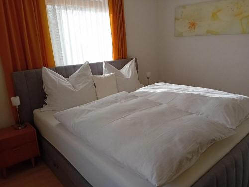 a large white bed with white sheets and pillows at Gasthof-Pension Zum Haugstein - Familie Eder in Engelhartszell