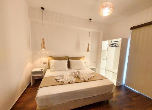 a bedroom with a bed with two towels on it at POLYMNIA III LUXURY APARTMENT ARGOSTOLI in Argostoli