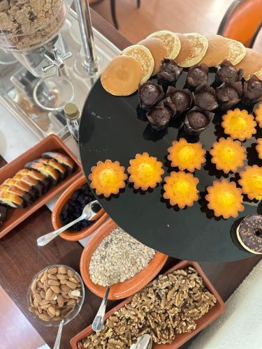 a table topped with different types of food and flowers at Hotel Joao Padeiro in Aveiro