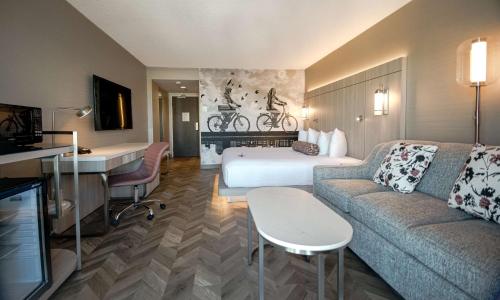 a hotel room with a couch and a bed at Coast Victoria Hotel & Marina by APA in Victoria