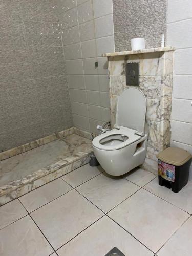 a bathroom with a white toilet in a room at شقة مفروشة للايجار in Irbid