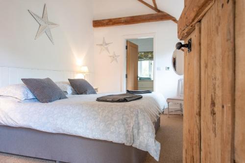 a bedroom with a large white bed with stars on the wall at The Granary in Yeovil