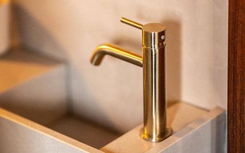 a metallic sink with a gold faucet in a bathroom at Houseboat-Amsterdam-Classic in Amsterdam