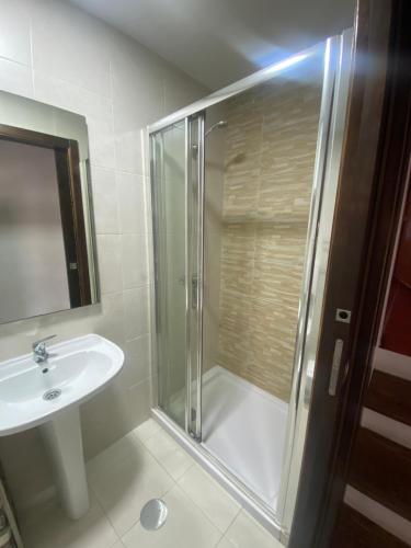 a bathroom with a shower and a sink at Rabacal Hotel Suite B&B with pool in Chanca