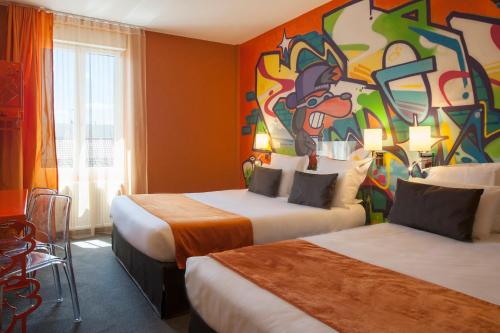 a hotel room with two beds and a painting on the wall at The Originals Boutique, Hôtel de l'Univers, Montluçon in Montluçon