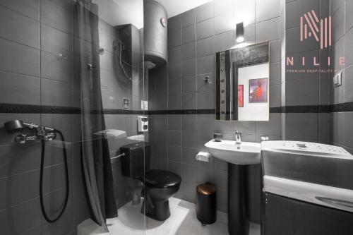 a bathroom with a sink and a shower and a toilet at Rocco, Nilie Hospitality MGMT in Thessaloniki