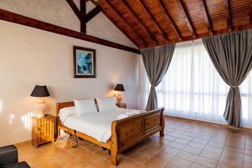 um quarto com uma cama e uma grande janela em Villa Micaela em Lamadrid