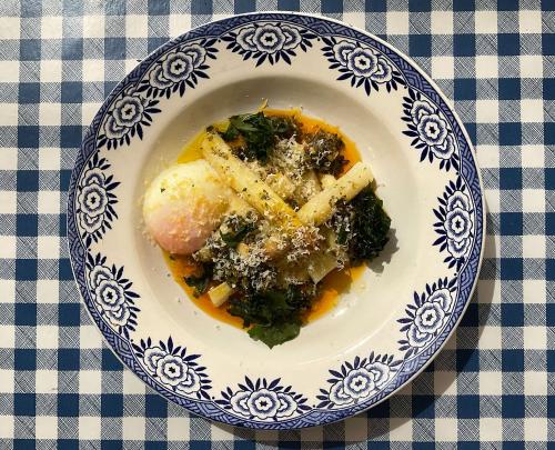 a blue and white plate of food on a table at Chez Rosette de Lussan in Lussan