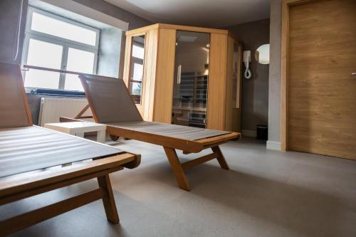 a wooden bench sitting in a room at Luxury Holiday Home With Wellness in Binsfeld
