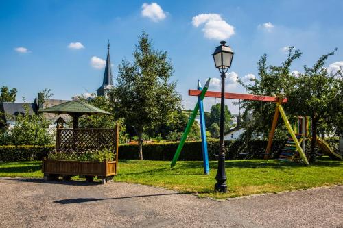 a park with a swing set and a street light at Luxury Holiday Home With Wellness in Binsfeld