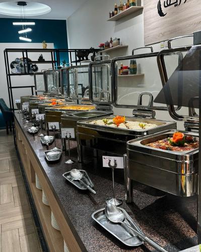 a buffet line with many different types of food at Le Reve Hotel إحدى فنادق مجموعة لوريف By Le Reve Company in Taif