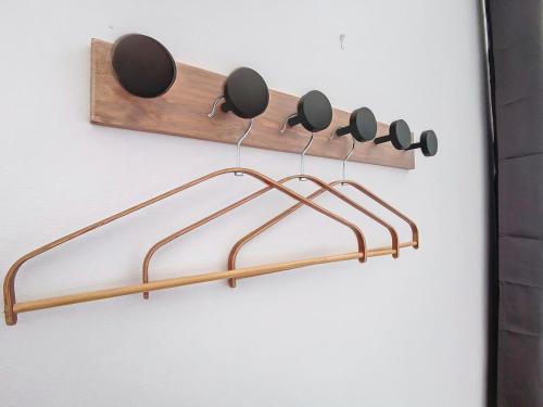 a wooden rack with nine cups on a wall at Le Relais de Fleyres - Gîte Authentique avec Jardin, Parking et Wifi in Toulouse