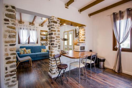 - un salon avec une table et un canapé bleu dans l'établissement Alexander Aqua Oasis - Poolside Garden Getaway, à Evkarpía