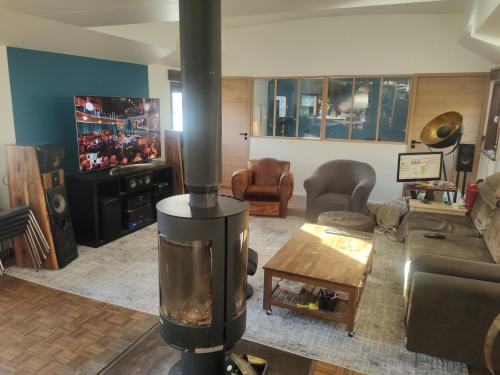 a living room with a wood stove in the middle at Experience Paris 2024 from la Seine in Villeneuve-la-Garenne