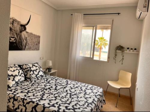 a bedroom with a bed and a desk and a window at Casa Rio in Rojales