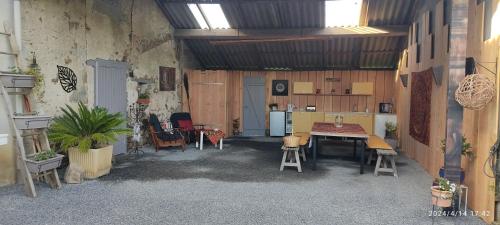Habitación con mesa, sillas y cocina. en Respire O'Dorat chambres privées dans havre de paix, en Le Dorat