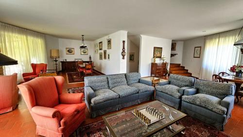 a living room with two couches and two chairs at La Piccola Rocca in Cetona