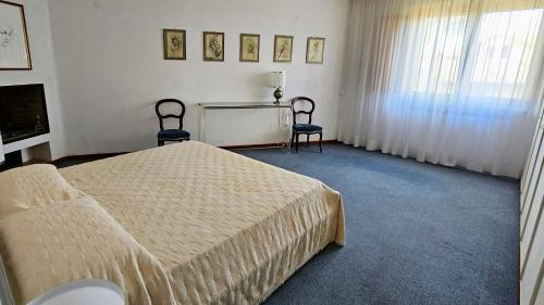 a bedroom with a bed and two chairs in it at La Piccola Rocca in Cetona
