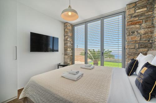 a bedroom with a large bed and a large window at Golden Haven in Murter