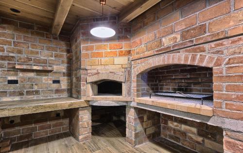 a brick oven in a room with a ceiling at Golden Haven in Murter