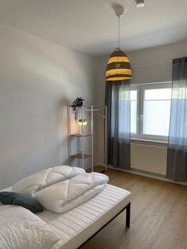 a bedroom with a bed and a window and a lamp at Schöne Erdgeschoss-Wohnung in Bremen in Bremen