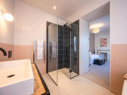 a bathroom with a glass shower with a sink at Pass the Keys London Spacious Dulwich family house with Pool in London