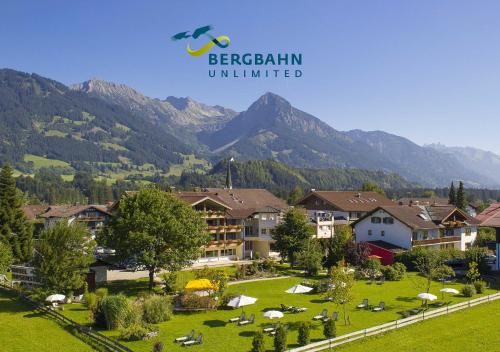 a view of a resort with mountains in the background at Hotel Rosenstock - Erwachsenenhotel - Adults only 15 plus in Fischen