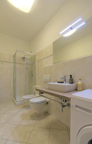 a bathroom with a toilet and a sink and a shower at Imola Residence in Imola