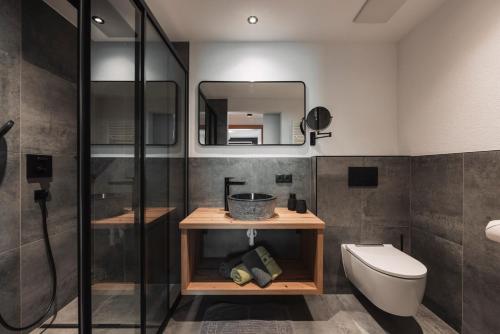 La salle de bains est pourvue d'une douche, de toilettes et d'un lavabo. dans l'établissement 4zero Appartment, à Umhausen