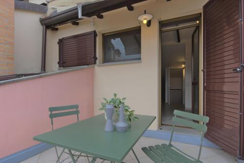a table and chairs sitting on a patio with a house at Imola Residence in Imola