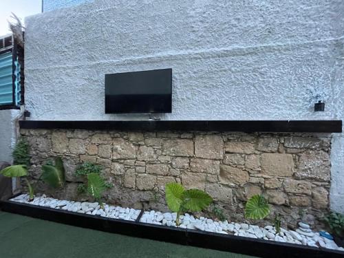 a building with a tv on the side of it at Hostel Marina in Nea Paphos