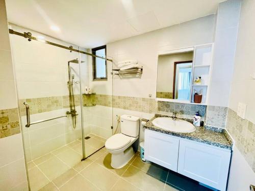 a bathroom with a toilet and a sink and a shower at Two Bedroom Happy Residence in Ho Chi Minh City