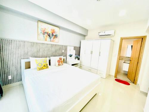 a white bedroom with a large white bed in it at Two Bedroom Happy Residence in Ho Chi Minh City