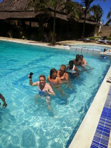 a group of people swimming in a swimming pool at Nightingale Apartments Hotel Mombasa in Shanzu