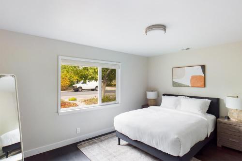 a bedroom with a white bed and a window at Santa Clara 3br w backyard ac nr park mall SFO-1564 in Santa Clara