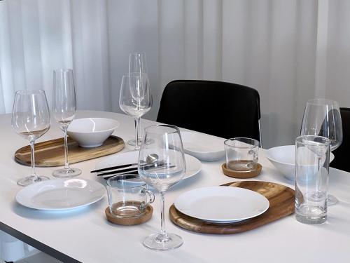 a table with wine glasses and plates on it at The Ball House in Daegu