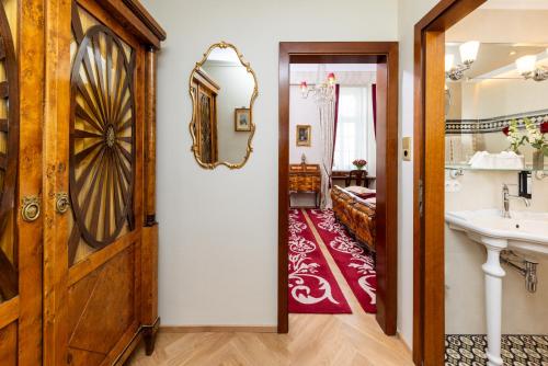 W łazience znajduje się umywalka i lustro. w obiekcie Hotel Stefanie - VIENNA'S OLDEST HOTEL w Wiedniu