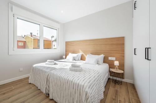 Ένα ή περισσότερα κρεβάτια σε δωμάτιο στο Apartamento White Tree by Arca Camelia