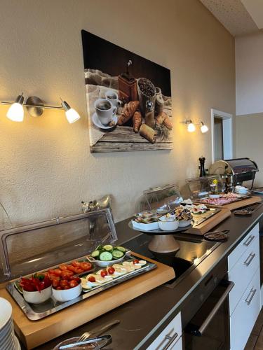 a kitchen with a buffet of food on a counter at Hotel an der Burg in Gießen