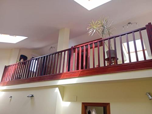 a staircase with a wooden railing in a building at Los acebos. Mar, montaña, cuevas in Rasines
