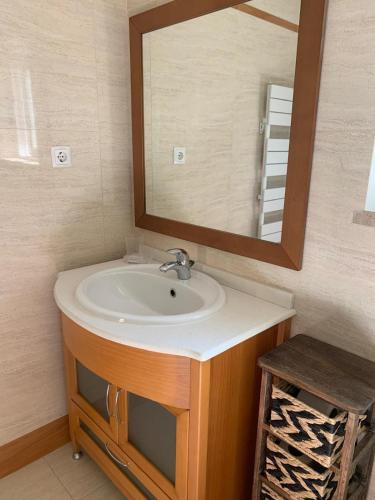 a bathroom with a sink and a mirror at Villa Luxsomar in Charneca