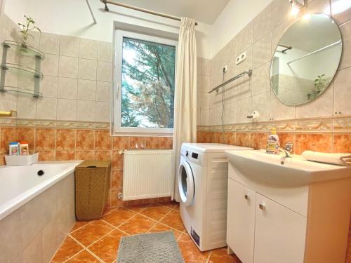 a bathroom with a sink and a washing machine at Langman Guesthouse in Budapest