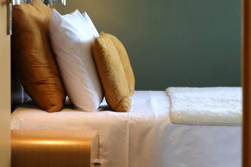 two pillows sitting on top of a bed at Le Sens Six in Montpellier