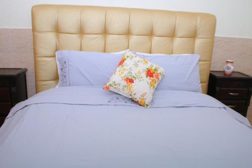 un letto bianco con due cuscini sopra di Charmant Appartement piscine à Bouznika a Bouznika