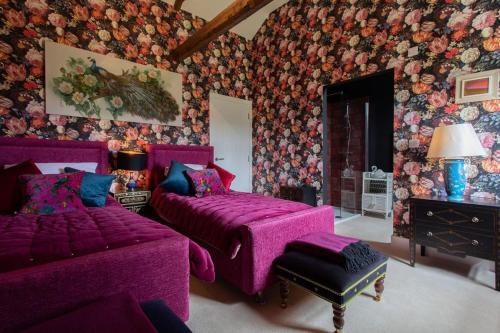 a living room with a purple bed and a couch at Lowtown Cottage in Brampton