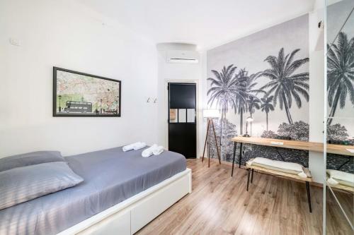 a bedroom with a bed and a desk and palm trees on the wall at Monte Carlo Monaco border, Center - See View - home feelings in Beausoleil