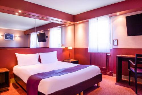 a hotel room with a bed and a tv at The Originals City, Hôtel Ascotel, Lille Est Grand Stade in Villeneuve d'Ascq